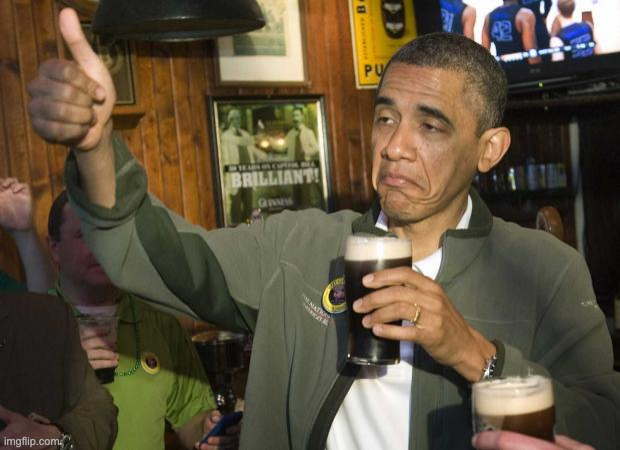 Barack Obama holding a drink and giving a cautious thumbs-up.