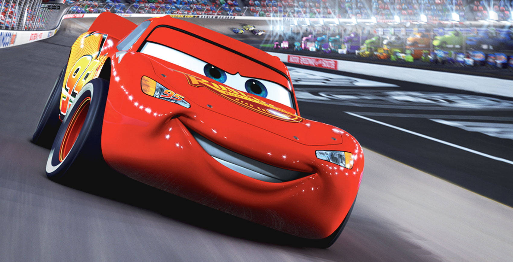 Lightning McQueen smiling while racing around a track.