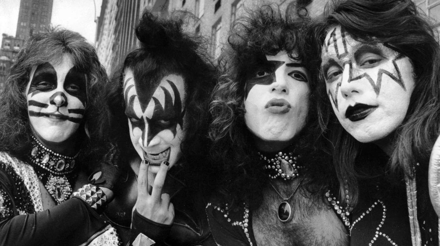 The four members of Kiss wearing their signature black-and-white stage makeup.